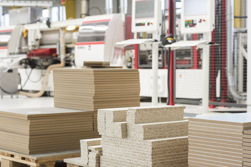 Boards stacked in front of edgebanders